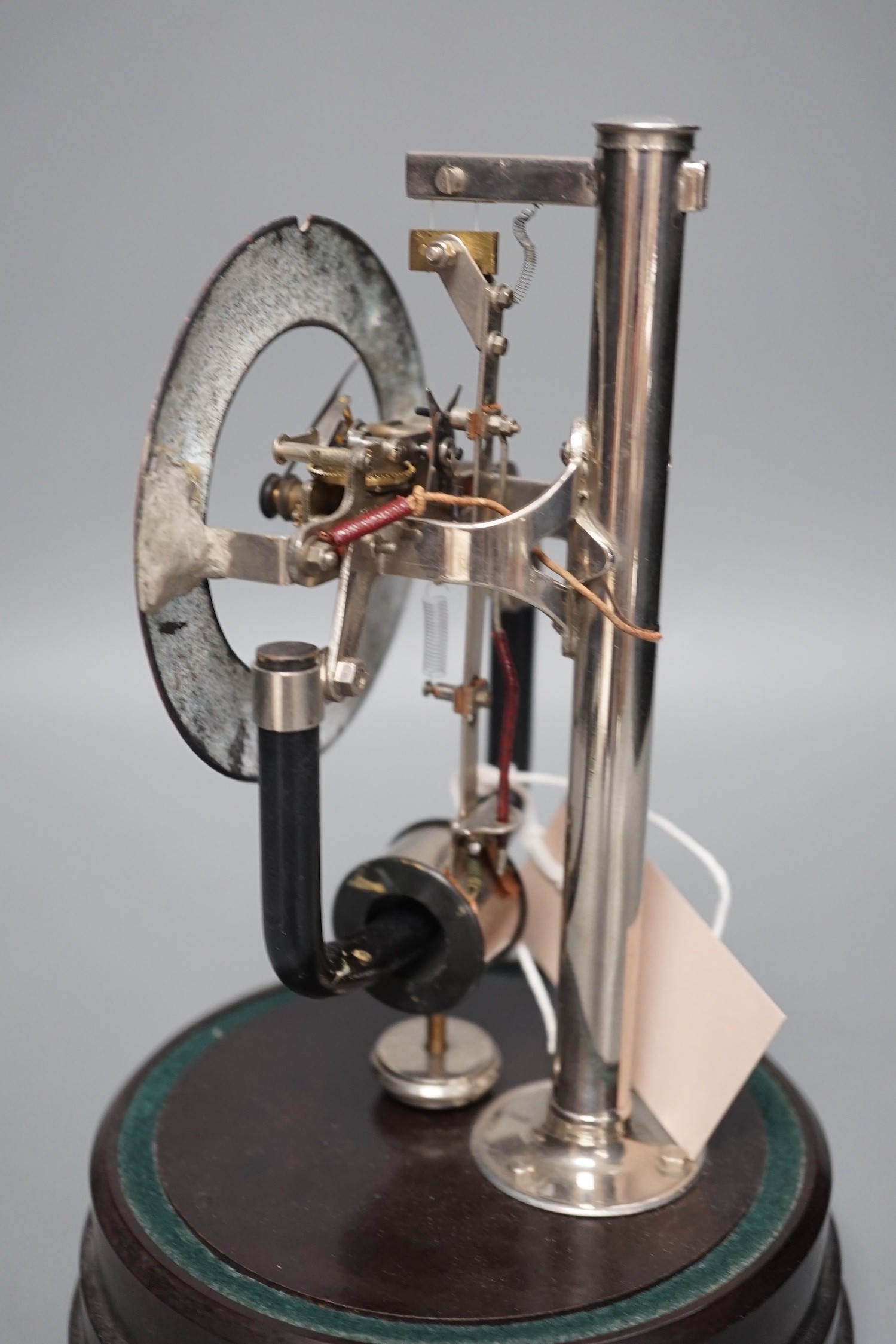 A 1930's electric mantel clock under glass dome, 26cms high